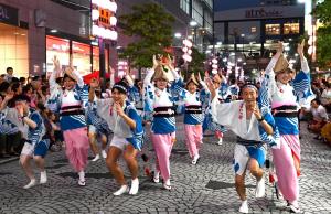 画像：多くの観客に囲まれながら踊り手たちが力強く踊っている（拡大画像へのリンク）