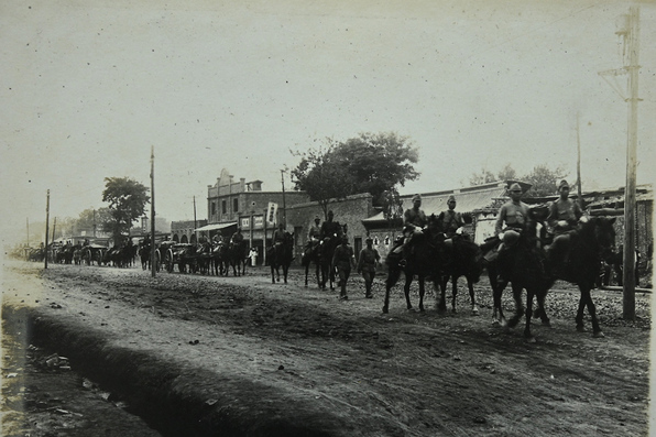 陸軍の長い行進が街中を進んでいる写真